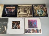 several albums of the rolling stones are on display on a table