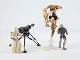 three figurines of star wars characters on a white background