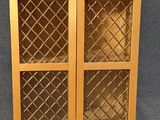 a close up of a wooden cabinet with glass doors