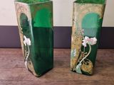 two vases that are sitting on a wooden table