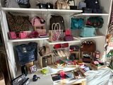 a room with a lot of purses and handbags on the shelves
