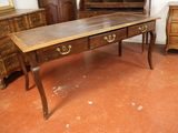 a wooden desk with two drawers and a mirror on it