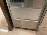 a stainless steel dishwasher in the corner of a kitchen