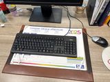 a computer on a desk with a keyboard and mouse