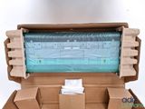 a cardboard box with a roll of plastic on top of it