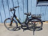 a bike that is parked in front of a blue building