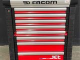 the red and black tool cabinet is sitting on the concrete floor