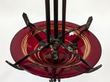 an image of a red and gold plate with forks on it
