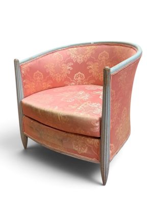 une chaise rose posée sur une surface blanche