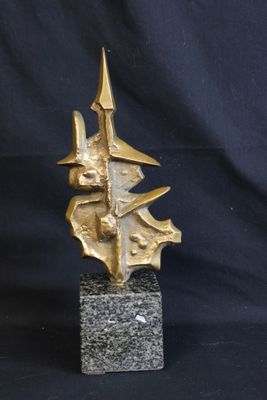 sculpture of a gold leaf on a black marble base