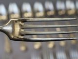 a fork that is sitting in front of a bunch of forks
