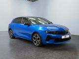 a blue car in a showroom with a black floor