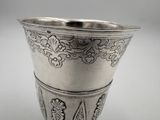 a silver cup that is sitting on a table