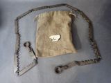a bag with a chain and a pair of scissors on it