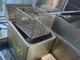 two deep fryers that are sitting in a kitchen