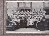 a group of people standing in front of a tank