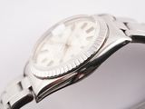 a watch that is sitting on a white surface