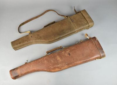 two old leather cases sitting next to each other on a white surface