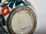 a close up of a vase with a tag on it