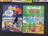 several comics are lined up on a black surface