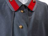 a close up of a mannequin wearing a uniform with a red collar