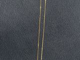 a close up of a necklace on a display on a table