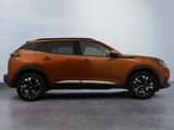 the orange nissan c - hr suv is parked in a large room