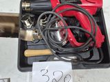 a black case with a red and black tool inside of it