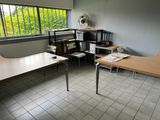 a desk and a chair in a room with a window