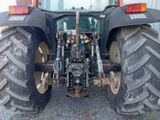 a large tractor that is parked in the gravel