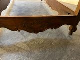 a bed that has a wooden frame on top of it