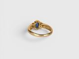 an image of a gold ring with a blue stone