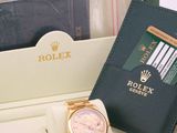 a watch and a passport in a box on a table