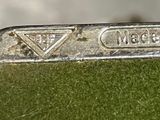 a close up of a metal object with a diamond on it