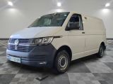the white van is parked on a checkered floor in the garage
