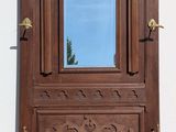 a wooden door with a mirror on the side of it