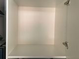 a white cupboard with a door open in a kitchen