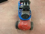 an image of a small air compressor on the floor