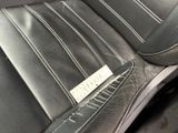 a close up of a car seat with a name tag on it