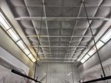 a large room with a lot of white walls and a ceiling