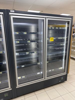two refrigerators that are sitting in the middle of a store