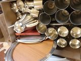 a box full of silver pans on a table