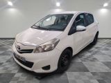 a picture of a white toyota yaris parked on a checkered floor