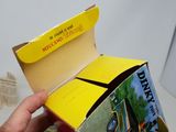 a person holding a box with a book inside of it