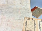 an old map of the united states with a book on it