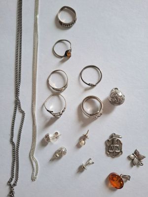 many different rings and necklaces laid out on a table