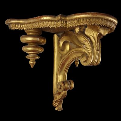 an image of a pair of gold brackets on a black background