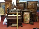 a piano in the middle of a room filled with furniture