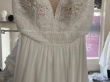 the back of a wedding dress hanging on a rack in a bridal shop