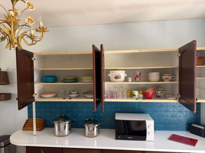 a small kitchen with a microwave and cabinets in it